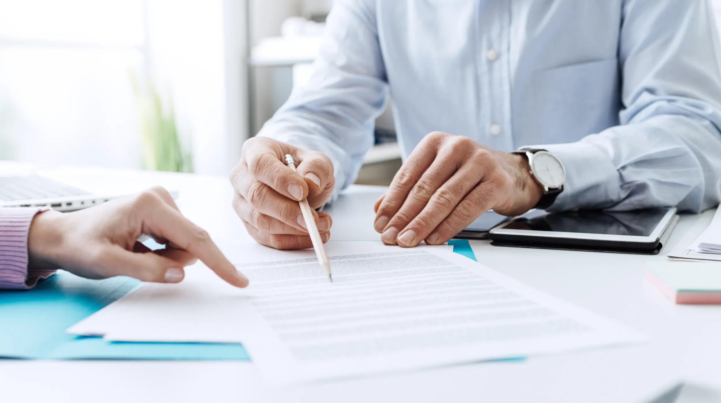 a person writing on a piece of paper