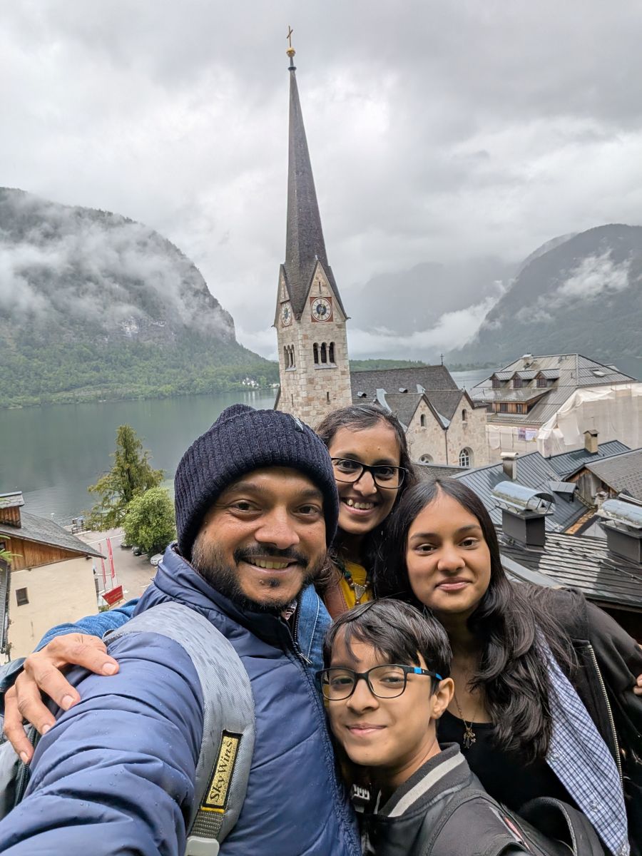 a group of people posing for a photo in front of a tall building