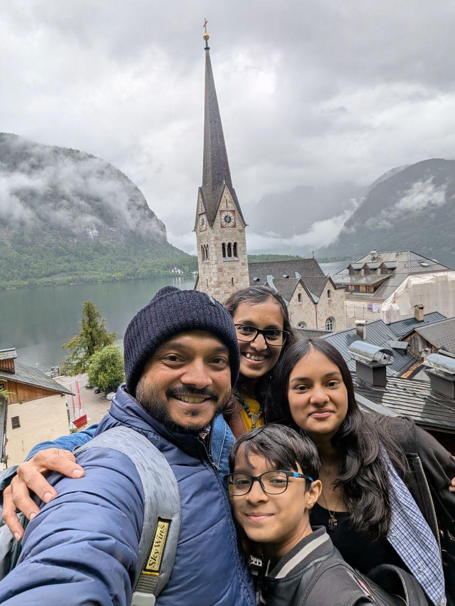 a group of people posing for a photo in front of a tall building