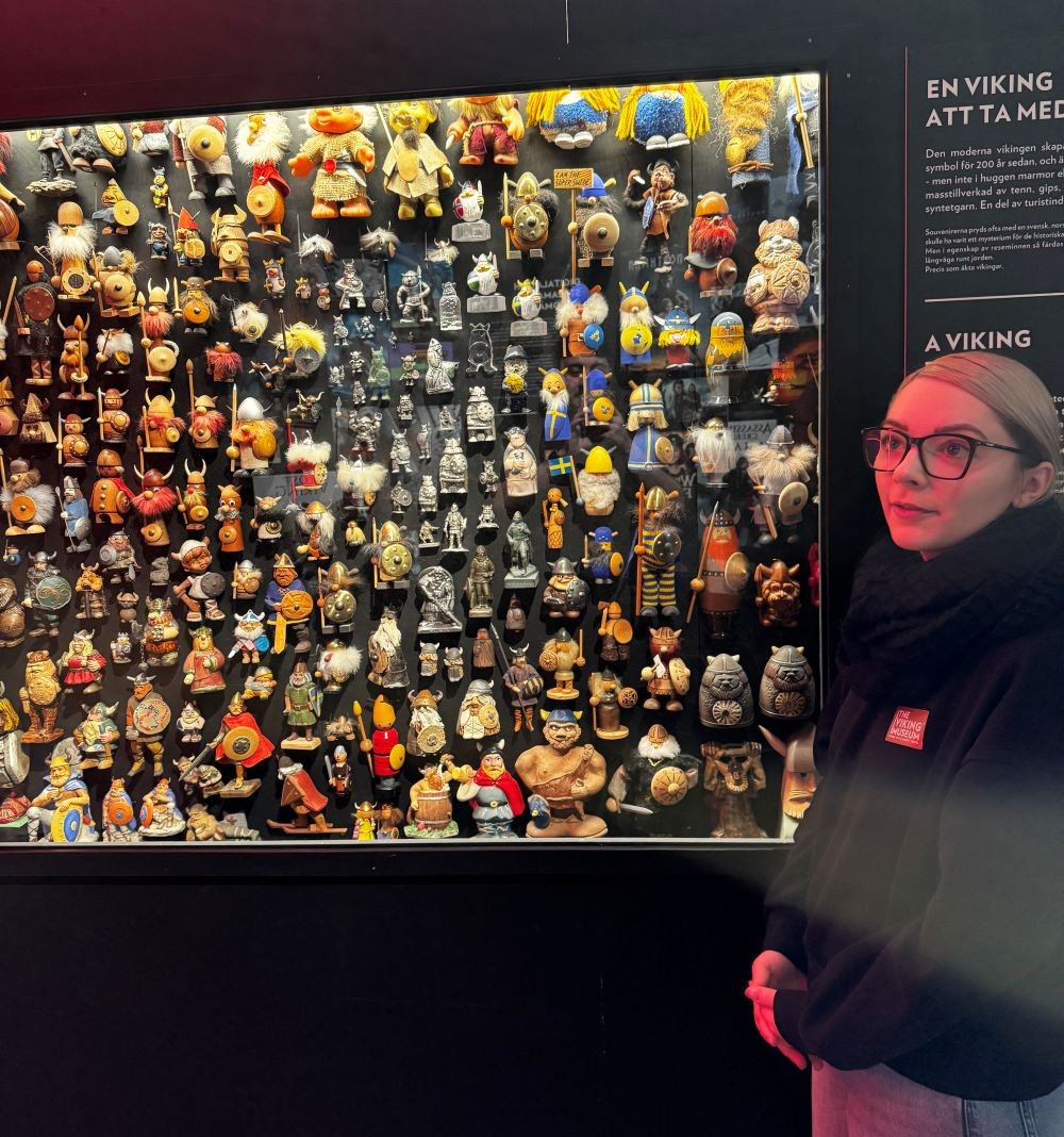 a person standing next to a display of figurines