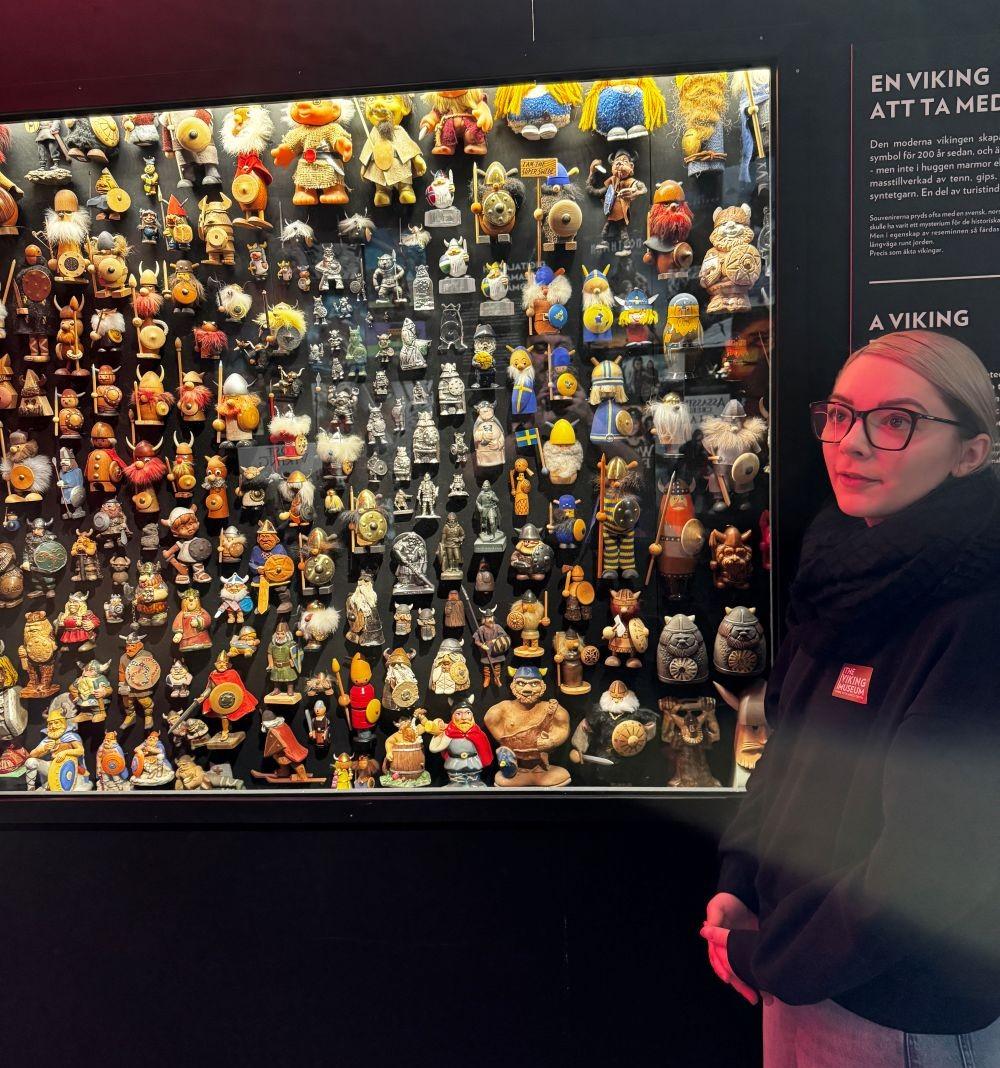 a person standing next to a display of figurines