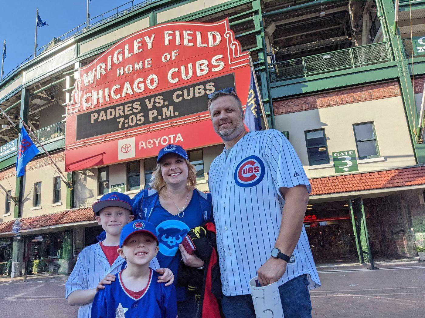 a family posing in front of a sign