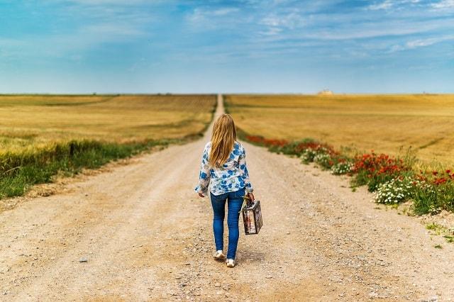Women With Suitcase Walking Down Road Illustrates Email Unsubscriber