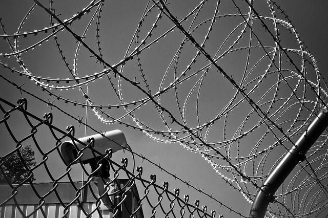 Barb Wire Fence Security Camera Illustrates EPP Code for Domain Security