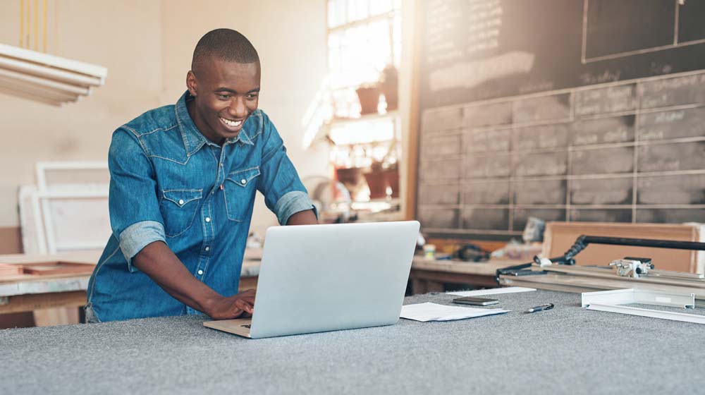 Build Online Presence Man in Workshop on Laptop