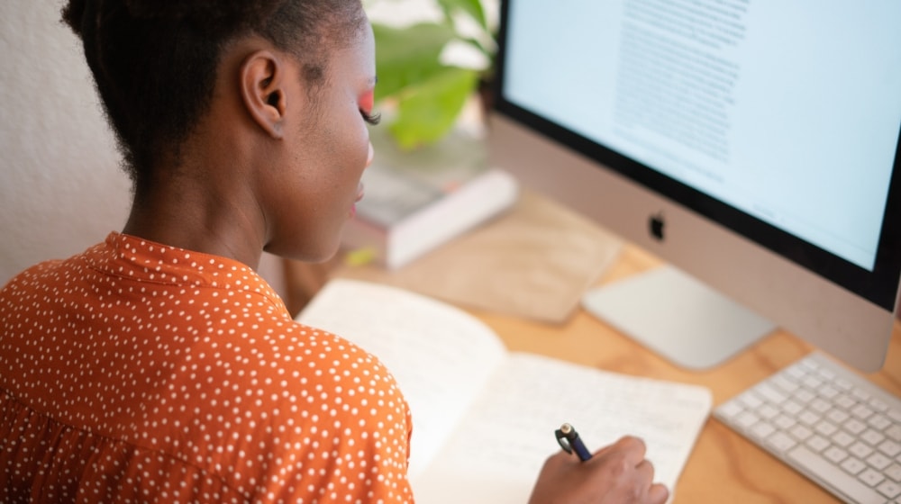 Creating A Newsletter African American Woman Writing