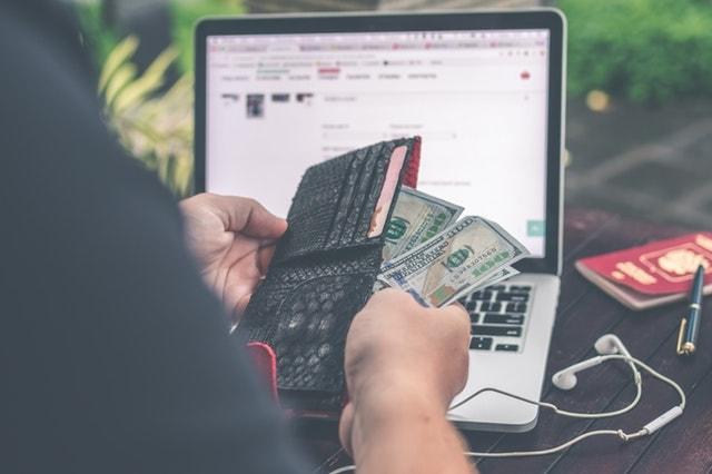 Man Holding Wallet With Money