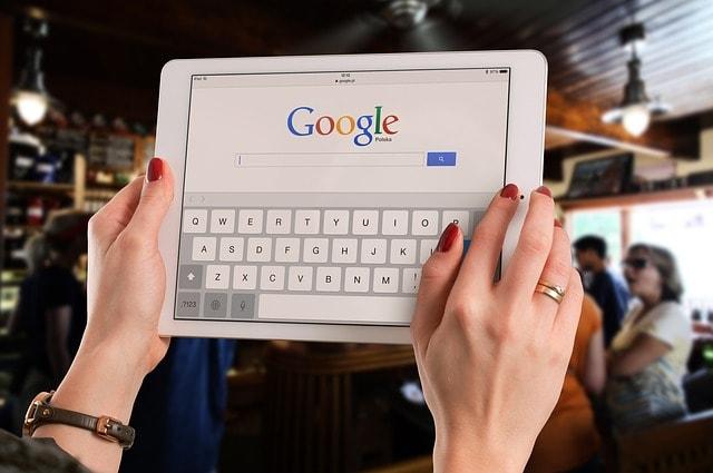 Woman Looking At Google Search On Tablet