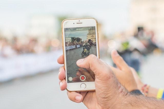 Email Signups Man Filming On Smartphone