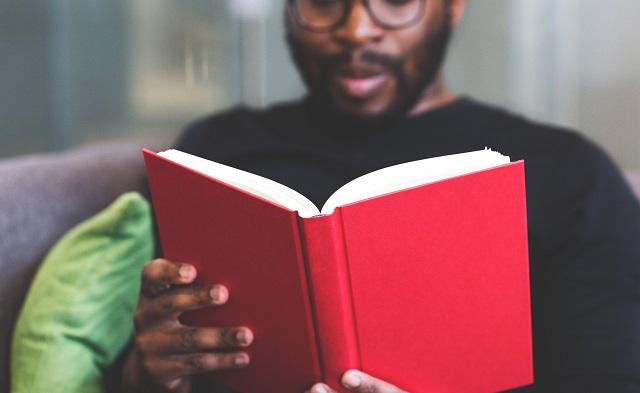 Man Reading A Book To Illustrate Continued Learning