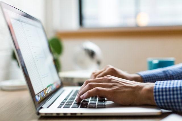 Facebook For Business Man Typing On Laptop