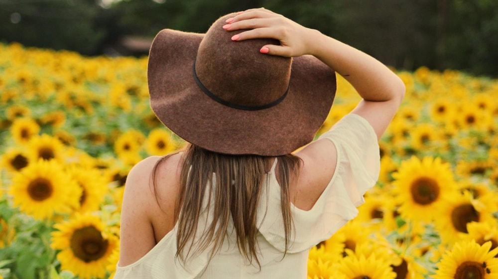 Fashion Lookbook Girl Standing In Front Of A Field Of Flowers