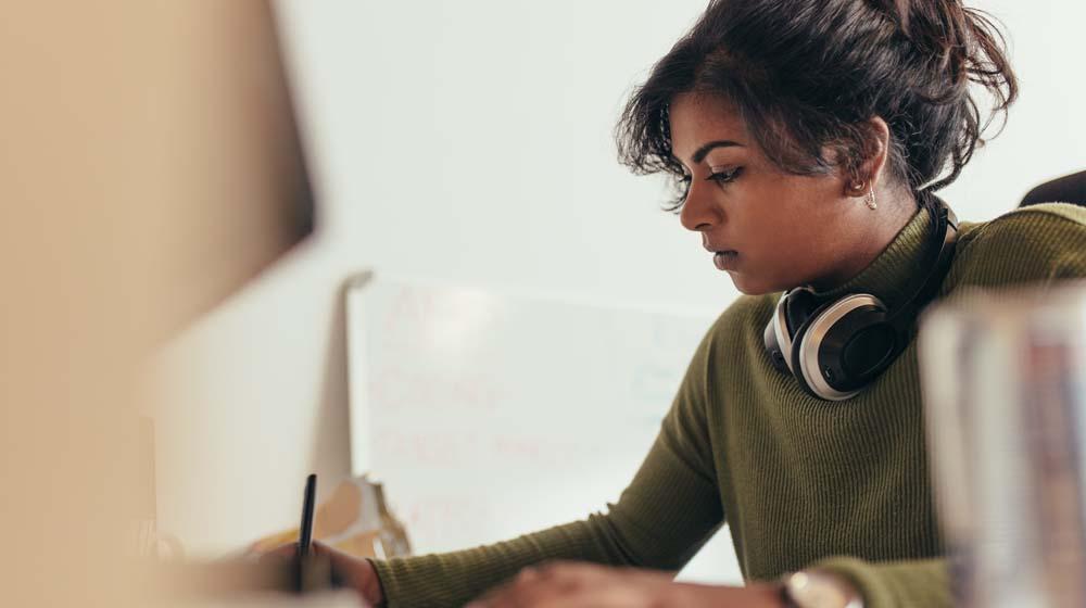 Female Programmer at Desktop Computer Represents How to Become Freelance Web Developer