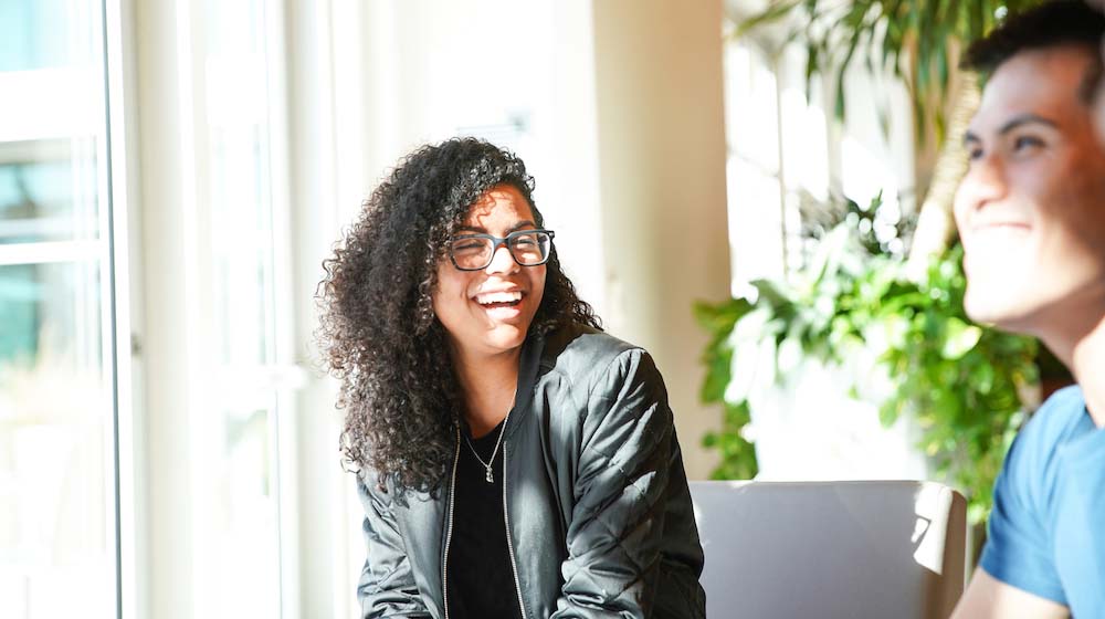 Female GoDaddy Employee Laughing Represents Womens Equality Day