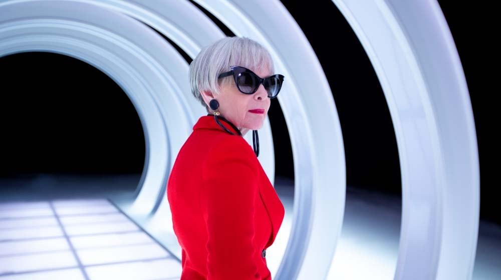 GoDaddy Lyn Slater Looking Over Shoulder in Red Blazer