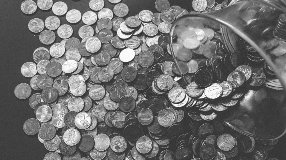 Coins being dumped out of a jar