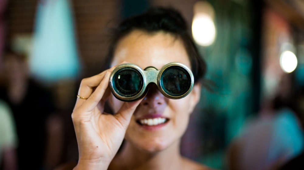 How To Increase Blog Traffic Woman Looking Through Binoculars