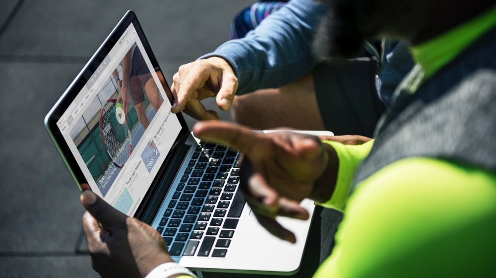 Two Men Using A Laptop
