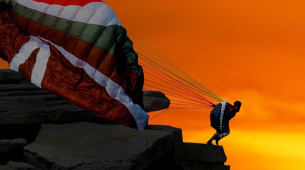 Jumping Off Cliff With Parachute Illustrates Building Confidence