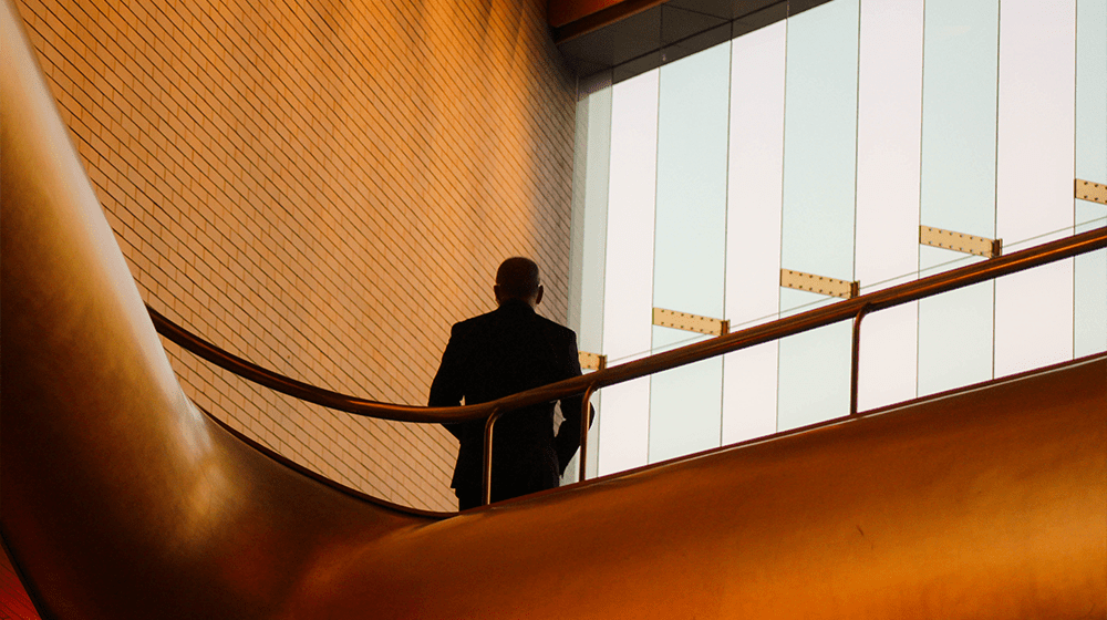 Man Standing in Stairwell Represents Growing Real Estate Business