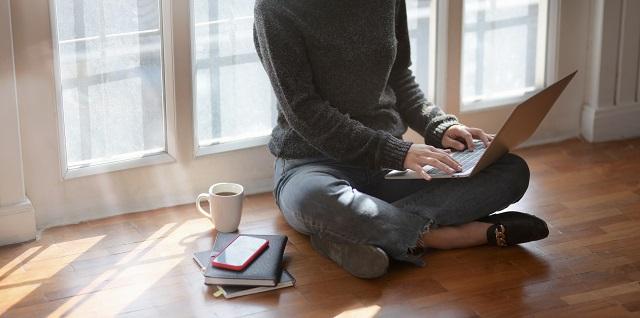 Woman Sitting On Floor With Laptop