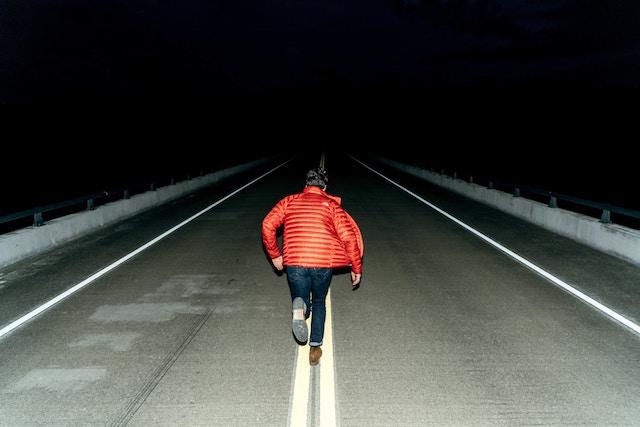 Man running down road a night