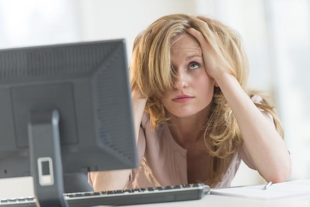 Frustrated Woman Sitting at Her Computer