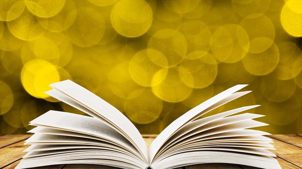 Open Book on Bright Yellow Background