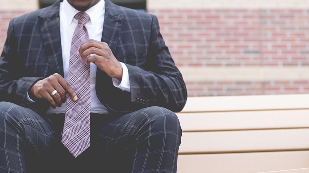 Man in business suit sitting on steps
