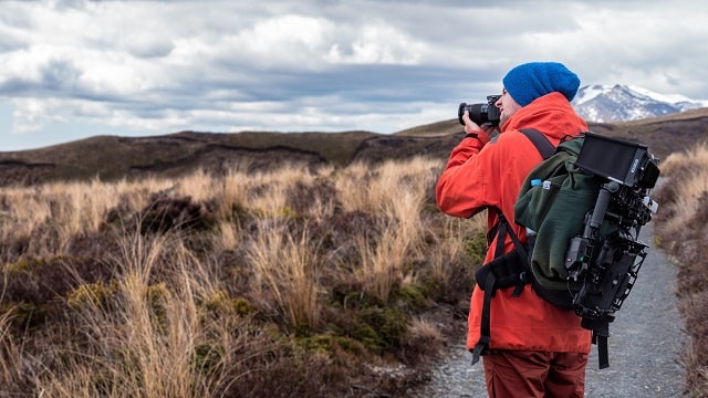 Man Hiking And Taking Pictures