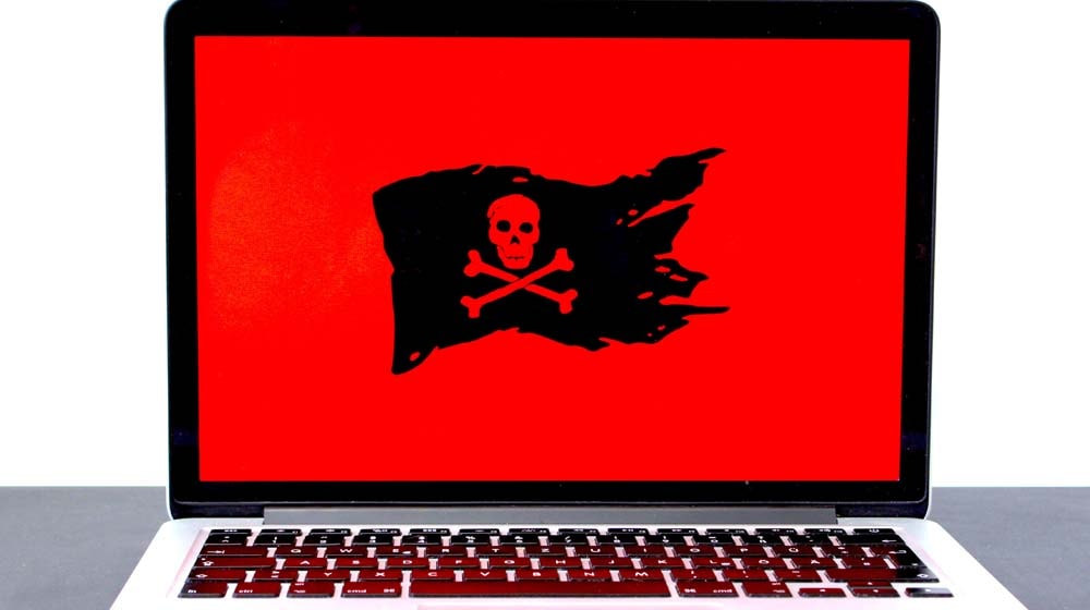 Skull on Macbook Screen Represents Website Security Threats