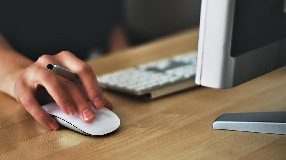 Person Using Desktop Computer Mouse To Develop Small Business SEO