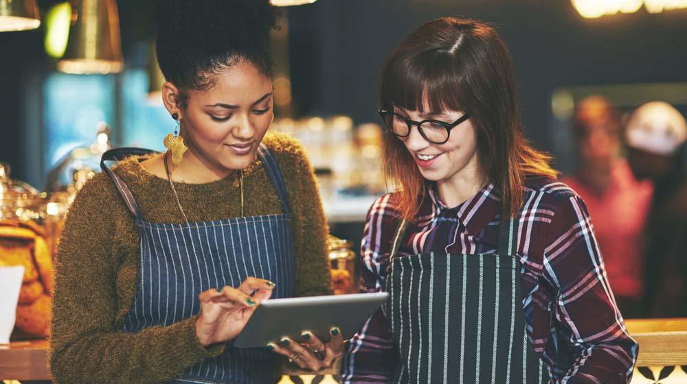 Small Business Website Two Female Entrepreneurs Looking at Tablet