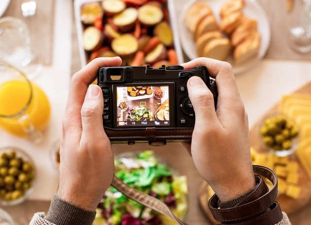 Person Taking A Photo Of Meal On Table