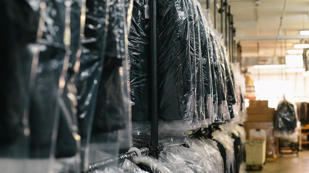 Suits in Warehouse Illustrate Inventory Management