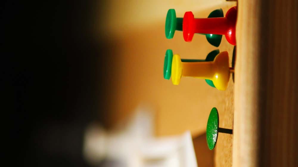 Tacks in Corkboard Illustrate Small Business Management