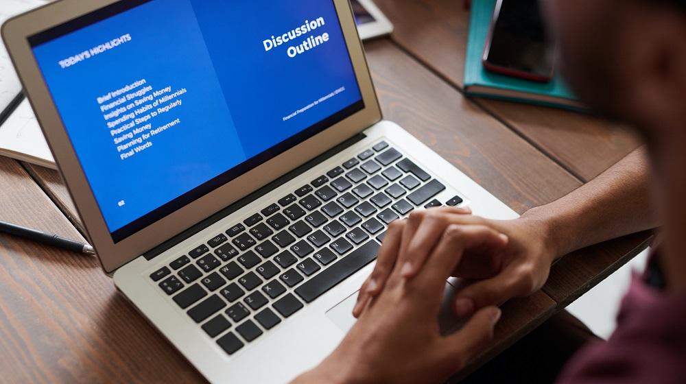 Man Sitting At Laptop Watching Online Learning Presentation