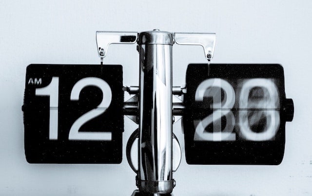 Time Ticking Away on Analog Alarm Clock Representing Time Management