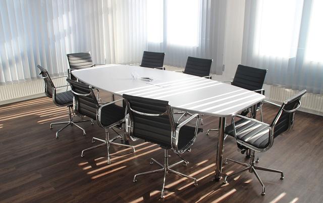 Empty Conference Room Table Surrounded By Chairs