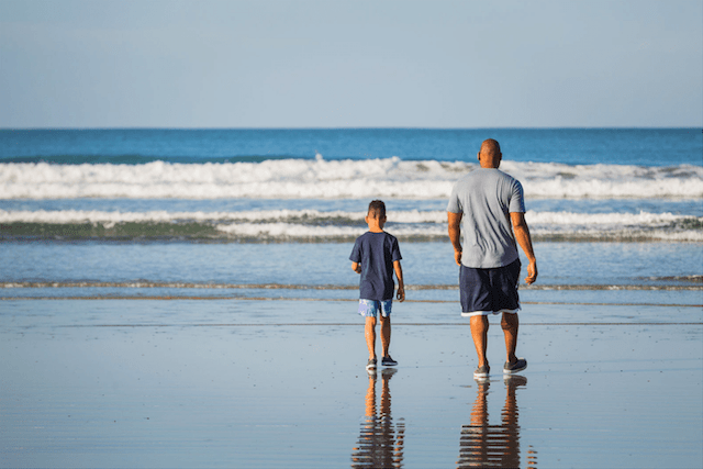 Tyson Toussant and Son Walking on Beach