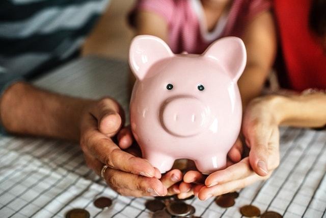 Update Business Plan Couple Holding Piggy Bank