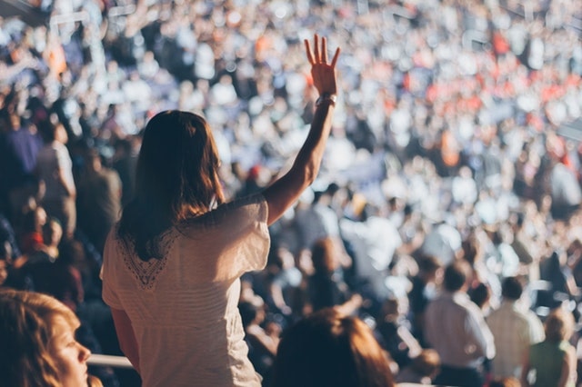 Validate Business Idea Woman Raising Hand In Audience