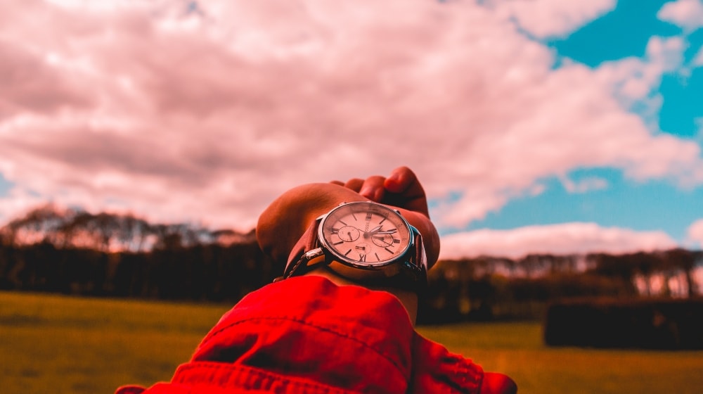 Watch With Clouds Backdrop Illustrates Time To Build Domain Name Portfolio
