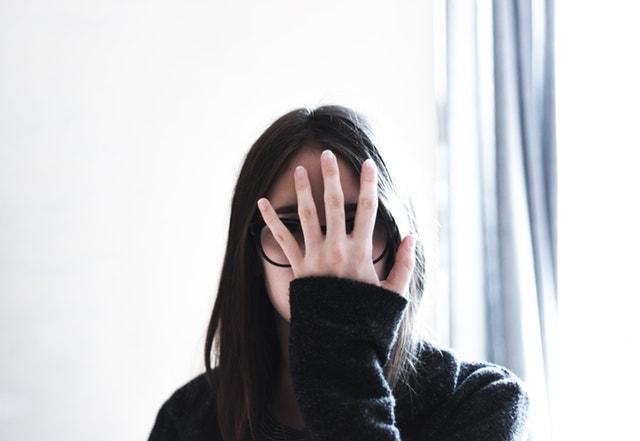 What Is Imposter Syndrome Woman Hiding Face