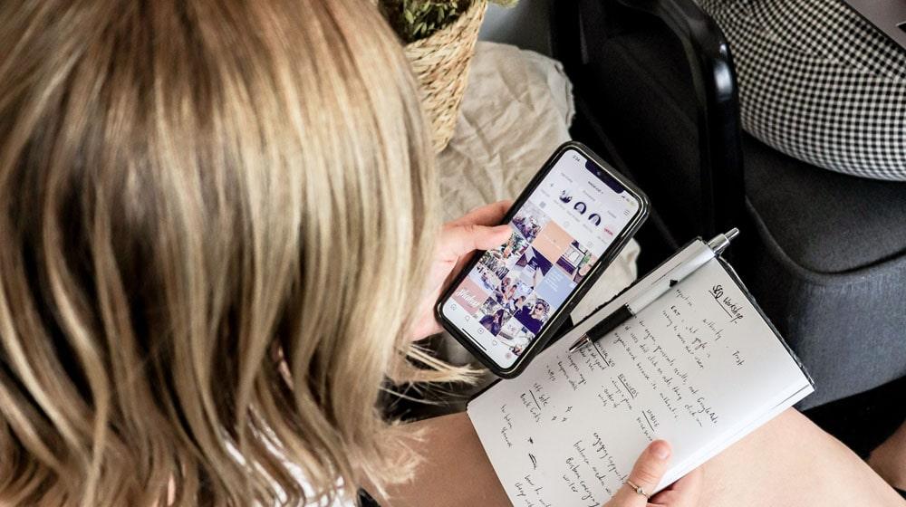 Woman Looking at Instagram on Phone Illustrates Instagram Marketing Strategy