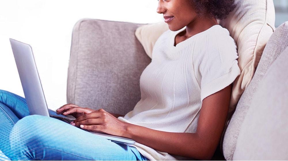 Woman Typing On Laptop Illustrates Domain Hacking