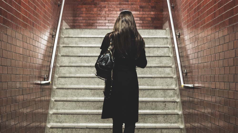 Woman Walking Alone Up Steps Illustrates Becoming A Solopreneur