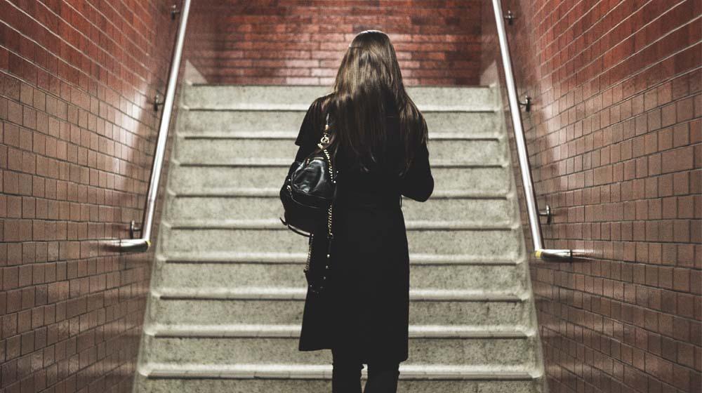 Woman Walking Alone Up Steps Illustrates Becoming A Solopreneur