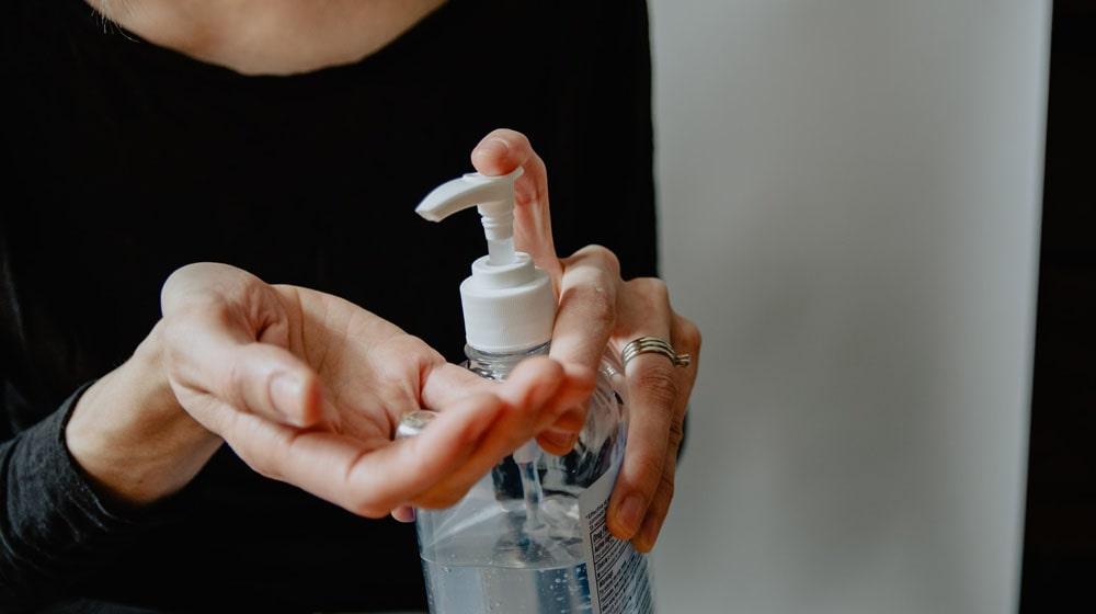 Woman with Hand Sanitizer Illustrates Sell Health Products
