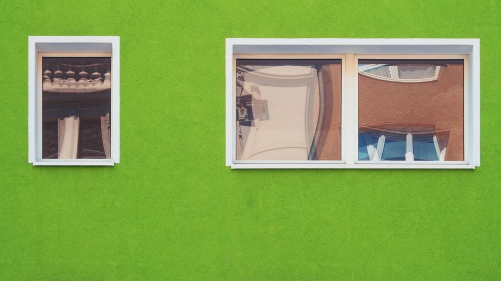 Green Home Exterior with Windows